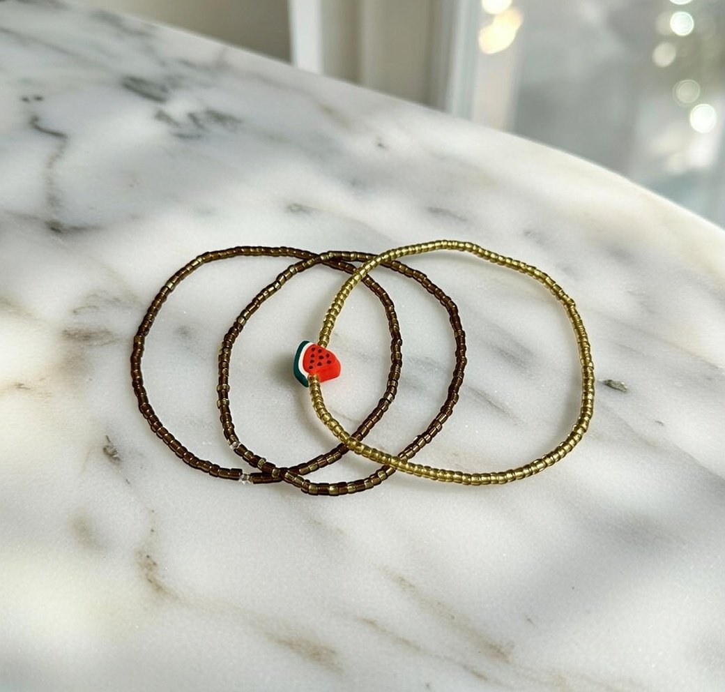 Al-Bireh Trio Bracelet Set — Three Gold and Brown Seed Bead Palestinian Bracelets with Watermelon Charm